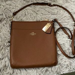 Tan crossbody Coach purse